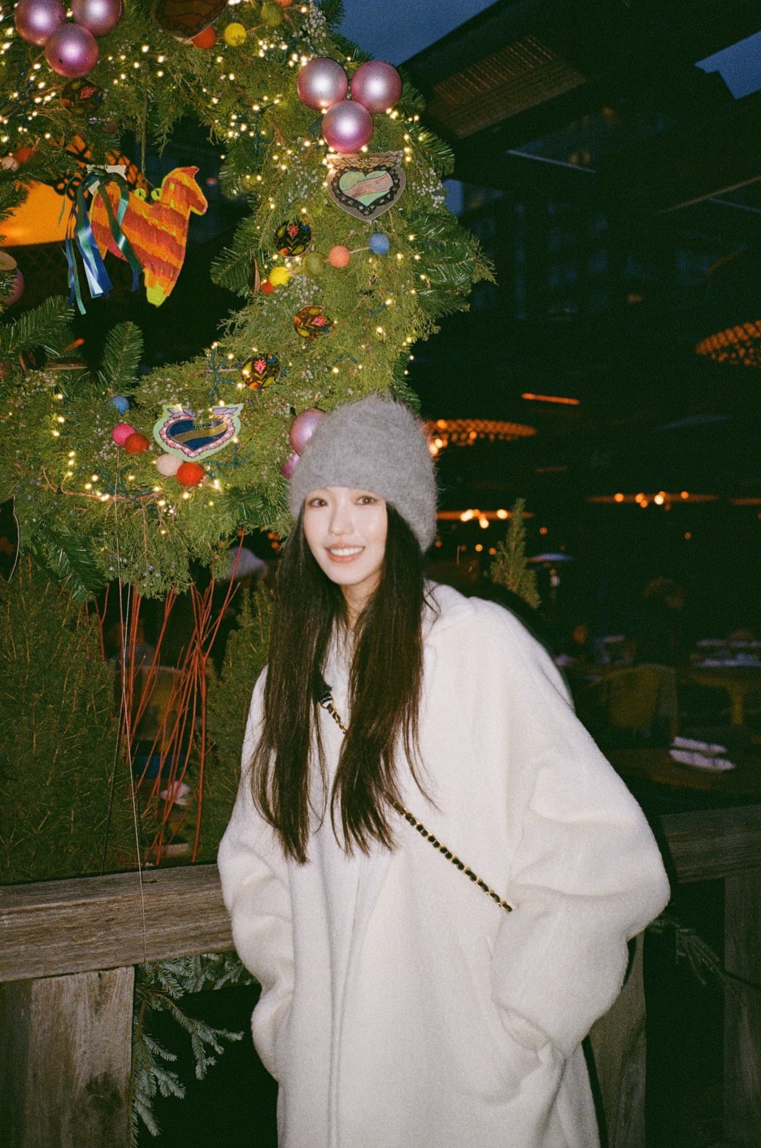 Maren Lian standing beside a decorated Christmas tree in Toronto